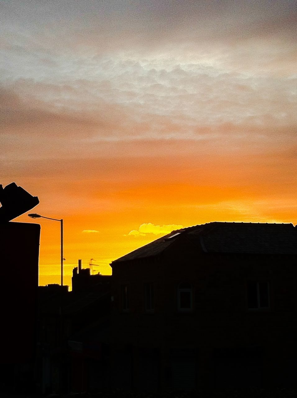 sunset, building exterior, architecture, built structure, orange color, sky, silhouette, house, low angle view, cloud - sky, residential structure, residential building, building, dramatic sky, cloud, outdoors, beauty in nature, cloudy, dusk, no people