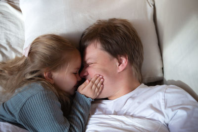 High angle view of boy sleeping on bed at home