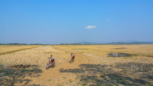 People on field against sky