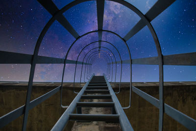Staircase against sky at night