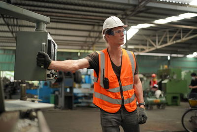 Portrait of male worker standing in the heavy industry manufacturing factory.