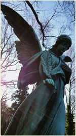 Low angle view of bare trees against sky