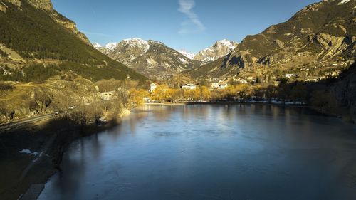 Scenic view of lake and mountains against sky