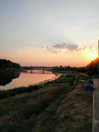 Scenic view of river at sunset