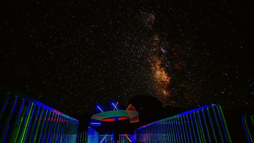 Low angle view of illuminated fireworks against sky at night