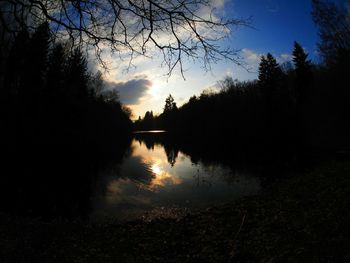 Scenic view of calm lake at sunset