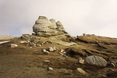 Rock formations on landscape against sky