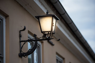 Low angle view of street light mounted on wall