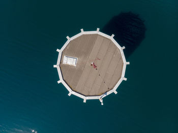 High angle view of building by sea against clear sky