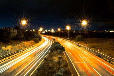 High angle view of light trails on road at night