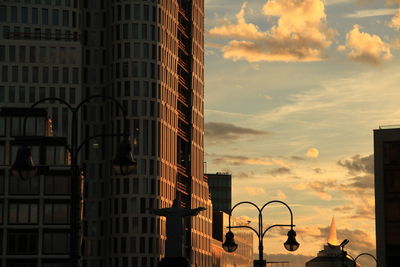 Low angle view of buildings against sky during sunset