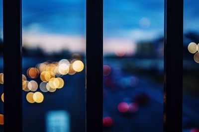 Close-up of illuminated bridge bars against sky