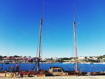 Sailboats sailing in sea against clear blue sky