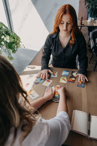 High angle view of woman sitting on table