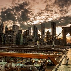 Modern buildings in city against sky during sunset