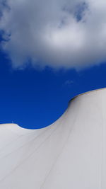 Low angle view of white car against blue sky