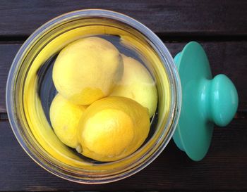 Directly above shot of lemons in container filled with water on table