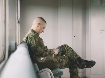 Side view of senior woman sitting in kitchen