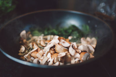 Close-up of chopped mushrooms and spinach in container