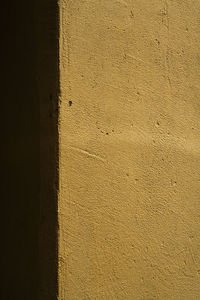 Close-up of yellow shadow on wall