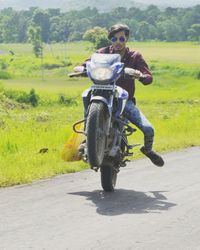 Man riding motorcycle on road