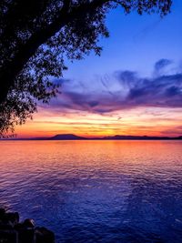 Scenic view of sea against romantic sky at sunset