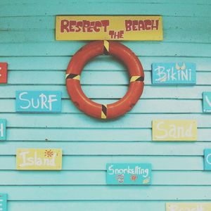 Close-up of information sign on wall