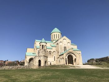 Low angle view of historical building against clear blue sky