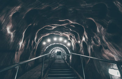 Low angle view of illuminated tunnel