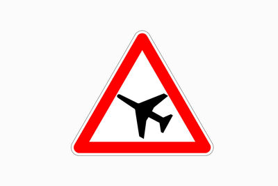 Close-up of road sign against white background