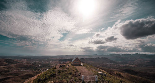 High view of house on cliff against cloudy sky