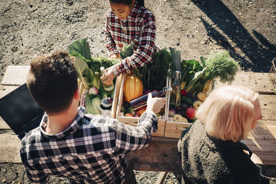 Rear view of people having food outdoors