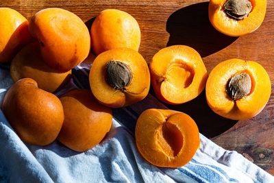 Robada freestone apricots halved on wood cutting board closeup details 