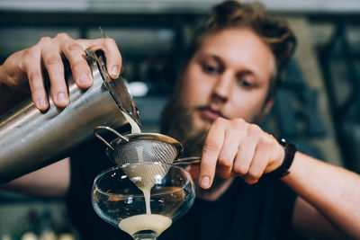 Barman preparing a cocktail in the bar.