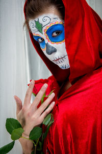 Portrait of woman holding rose