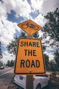 Road sign against sky