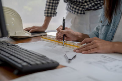Midsection of woman working on table