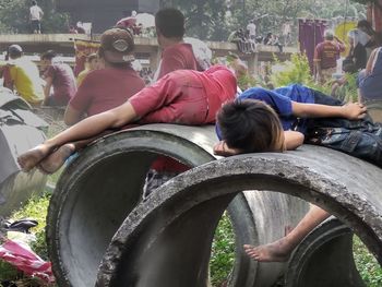 Rear view of people sitting in park