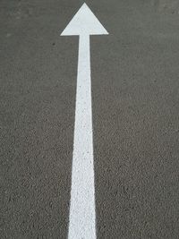 High angle view of arrow sign on road