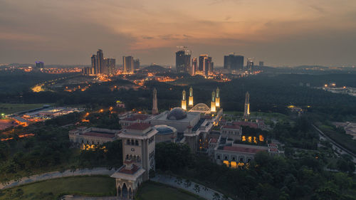 High angle view of buildings in city during sunset