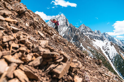 Climbing up rock slope on side of mountain in canadian rockies