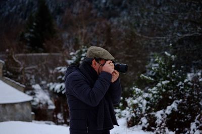 Man photographing from camera during winter