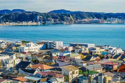 High angle view of townscape by sea