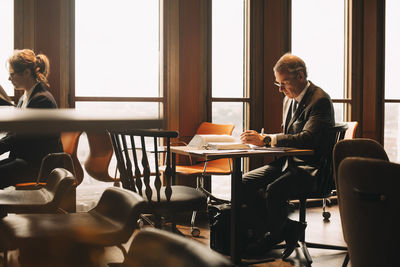 Lawyer studying evidences at table in office