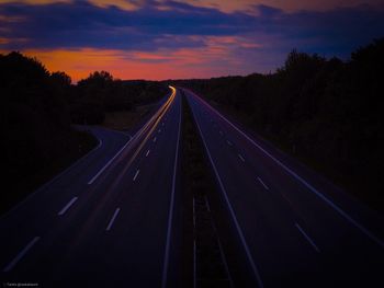 View of highway against sky at sunset