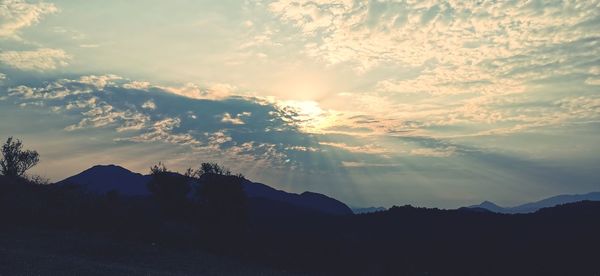Scenic view of silhouette mountains against sky during sunset