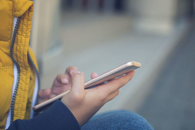 Close-up of woman hand holding mobile phone