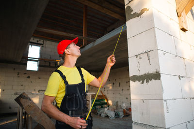 Rear view of woman standing against building