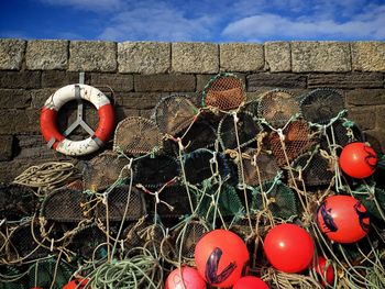 Fish raps with buoys against stone wall