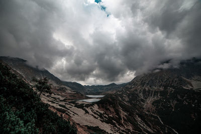 Scenic view of mountains against cloudy sky